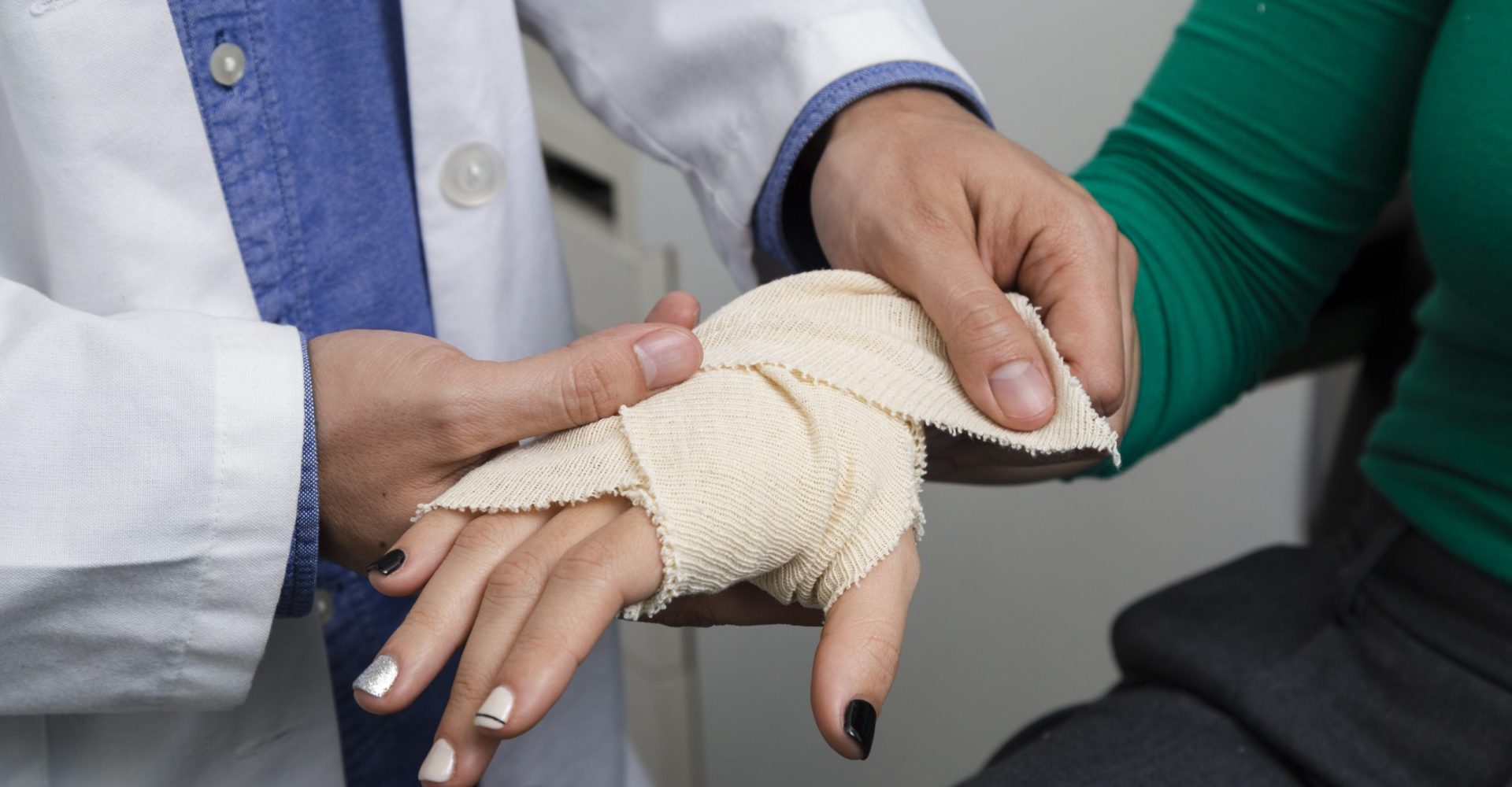 close-up-doctor-bandaging-arm